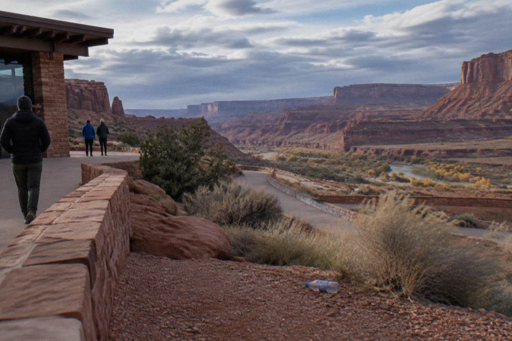 Deep canyon walls and river-cut mesas stretching to the horizon at dusk
