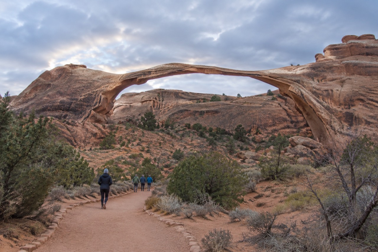 Red rock arches and canyon walls under a wide desert sky