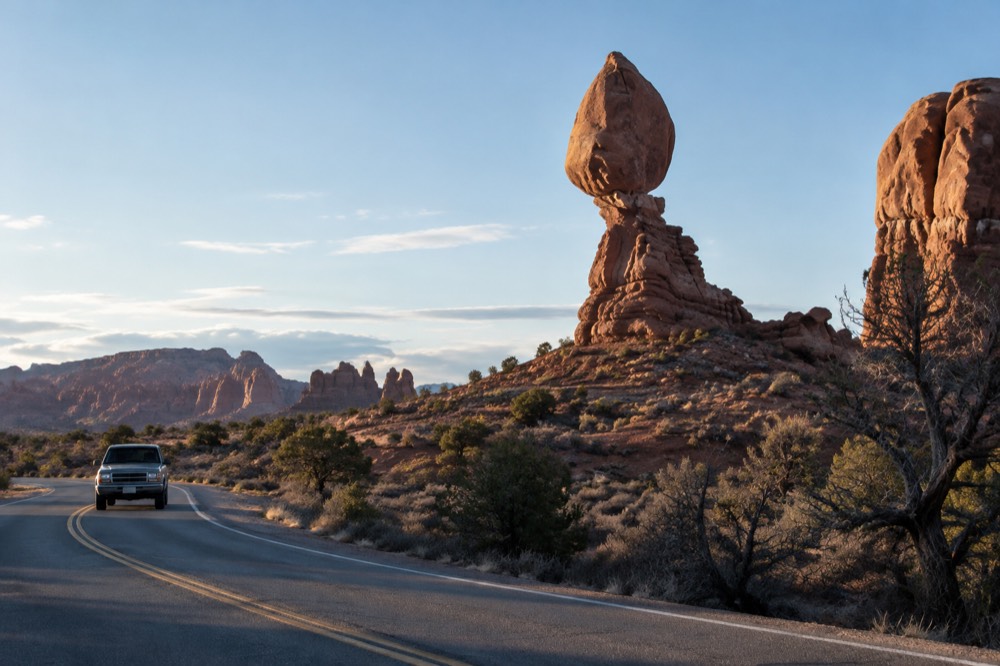 Four wheel drive vehicle on a slickrock road in Arches backcountry