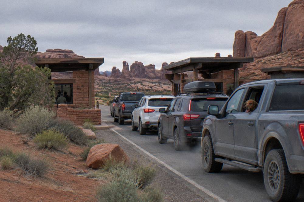 Long line of cars waiting at the Arches National Park entrance station