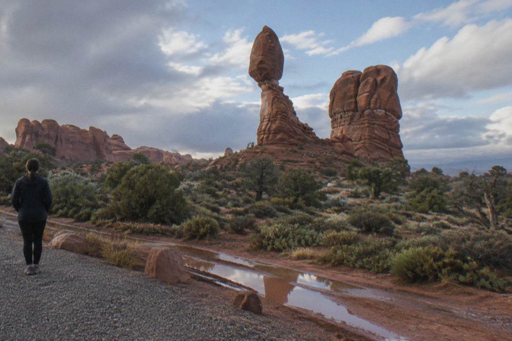 Balanced Rock rising above a desert plain seen from the roadside