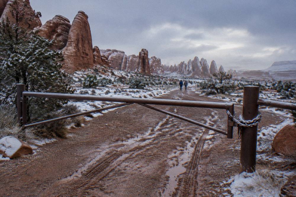 Closed metal gate and signage at the Fiery Furnace trailhead entrance
