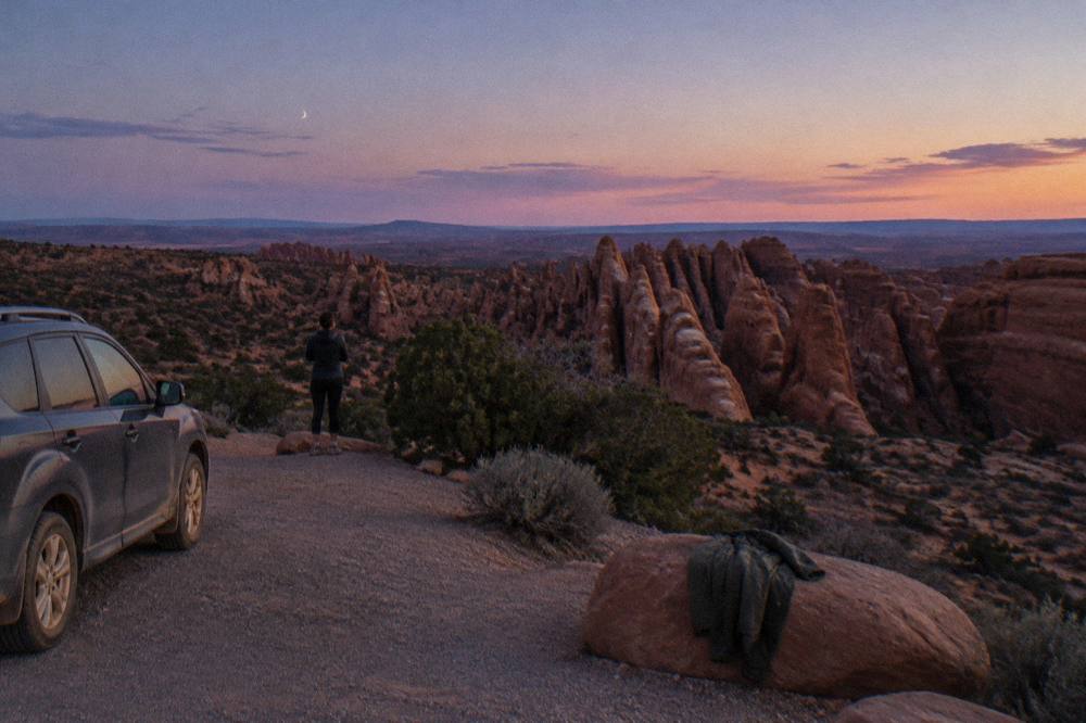Deep red sandstone formations under a fading twilight sky after sunset