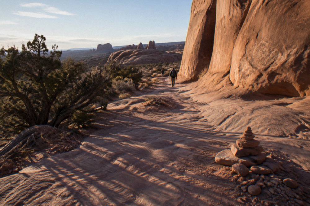Long shadows stretching across sandstone fins in the last hour of daylight